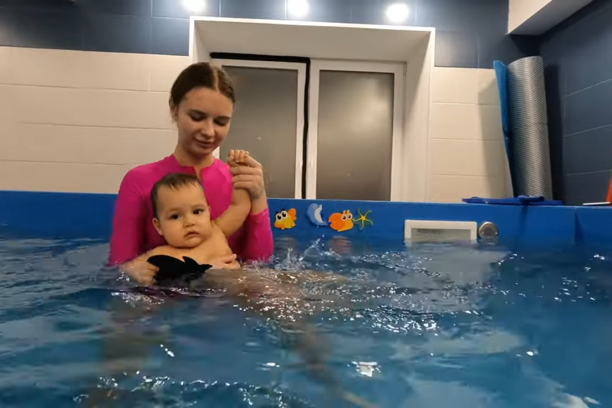 Baby swim class focusing on water confidence and drowning prevention skills